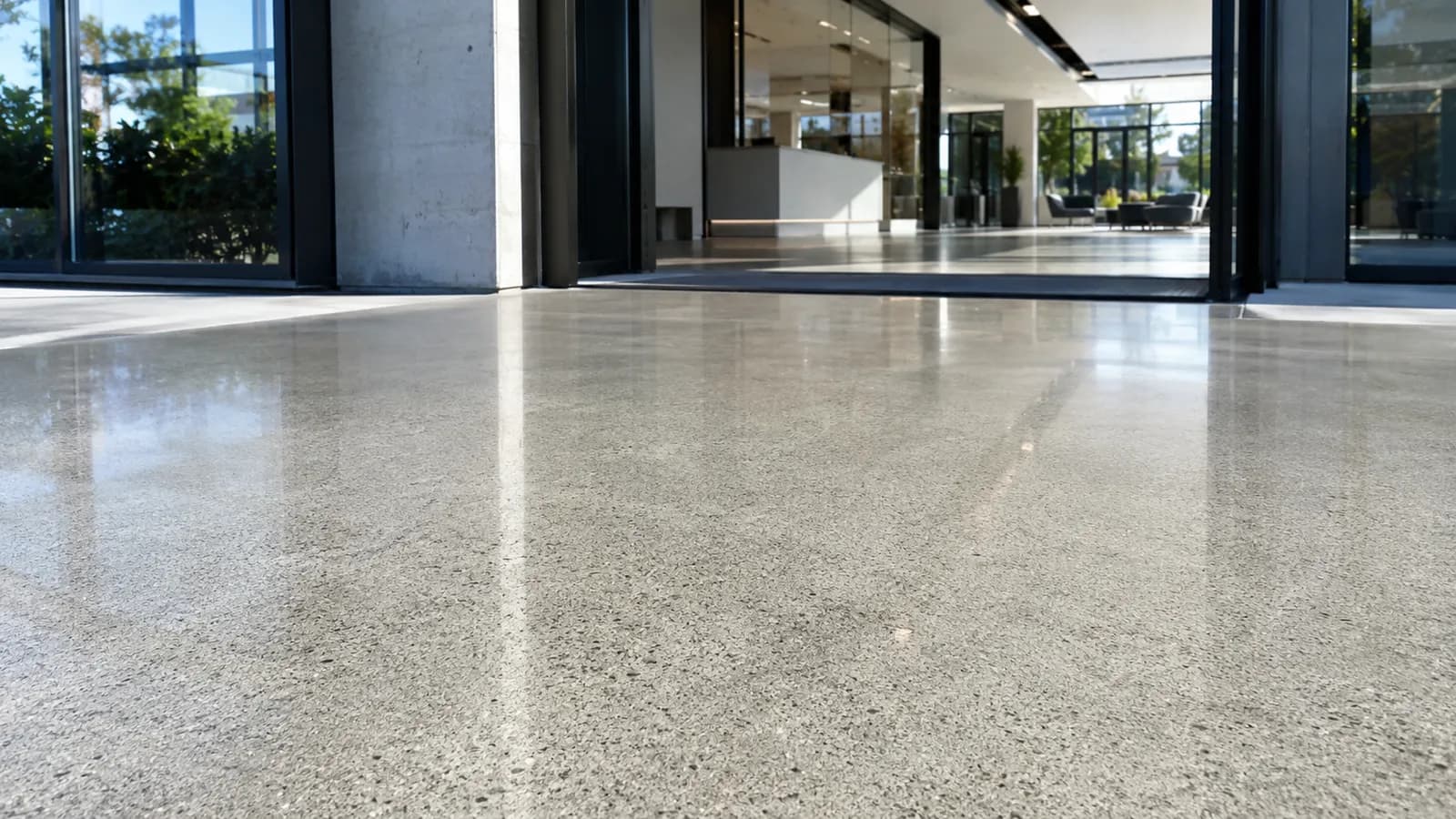 The same exterior concrete entrance with a polished, reflective finish after Duralyx Crystl Bond™ treatment.
