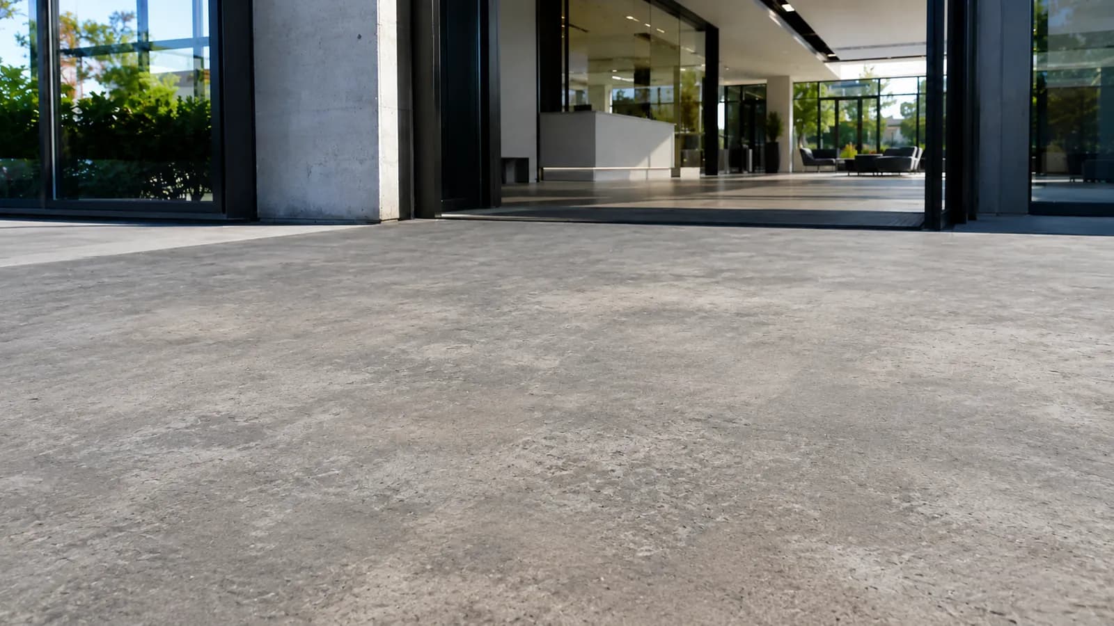 Exterior concrete entrance with a matte, weathered surface before treatment.